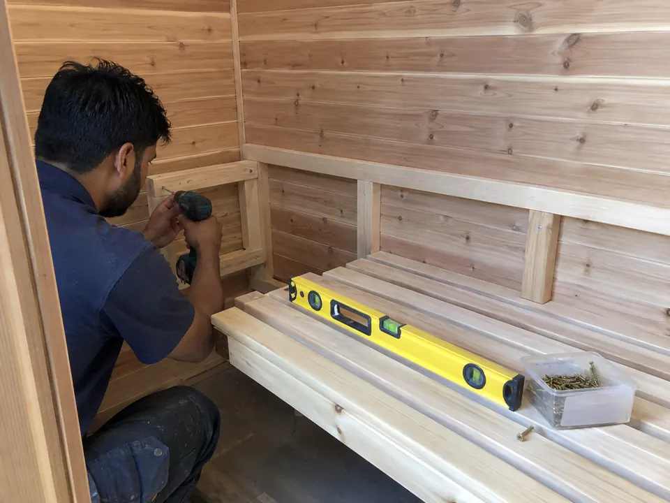 Assembly of wooden sauna cabin bench supports
